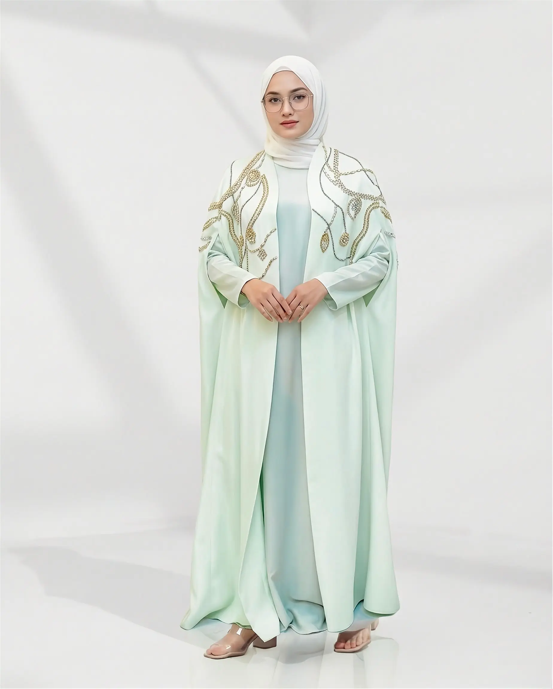 Introducing the Naoumi Reeves Barbie Crepe Cape Abaya: The Pinnacle of Luxury Modest Wear When it comes to high-end modest fashion, few pieces capture the essence of regal sophistication quite like the image 4