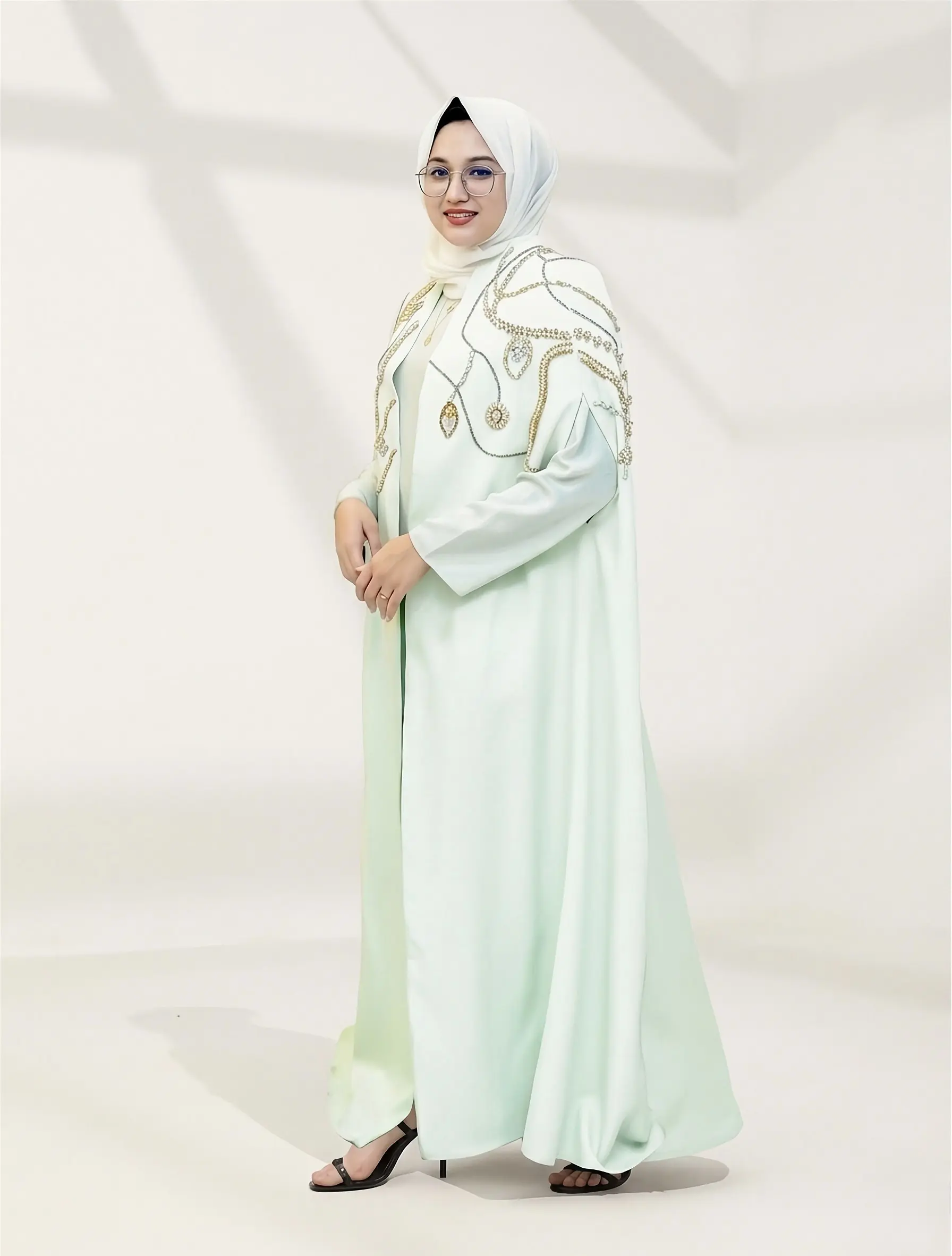 Introducing the Naoumi Reeves Barbie Crepe Cape Abaya: The Pinnacle of Luxury Modest Wear When it comes to high-end modest fashion, few pieces capture the essence of regal sophistication quite like the image 3